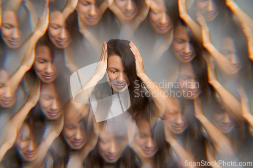 Image of Woman suffering from severe headache holding her head surround visual distortion