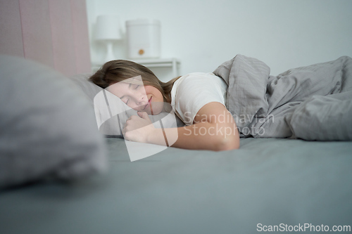 Image of Resting Peacefully Wrapped in Comfortable Bedding