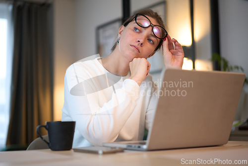 Image of Thoughtful Pause Above the Laptop Soft Glow