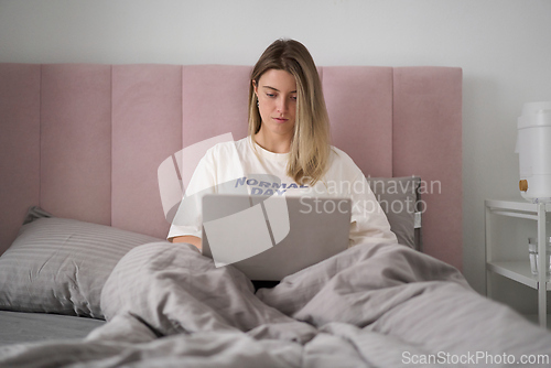 Image of Quiet Remote Work in a Softly Lit Bedroom