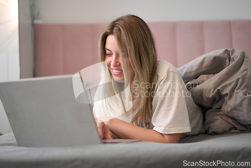 Image of Relaxed Browsing While Lying in Cozy Bedding
