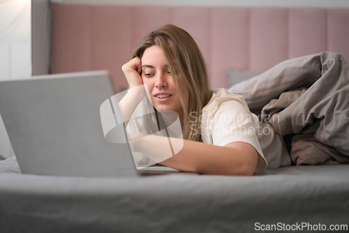 Image of Lighthearted Browsing While Resting Comfortably in Bed