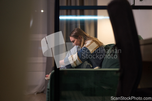 Image of young woman sitting alon on sofa - Loneliness and pain