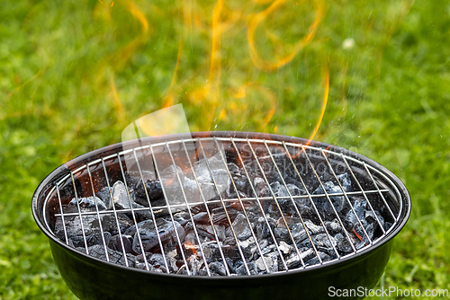 Image of empty burning charcoal grill