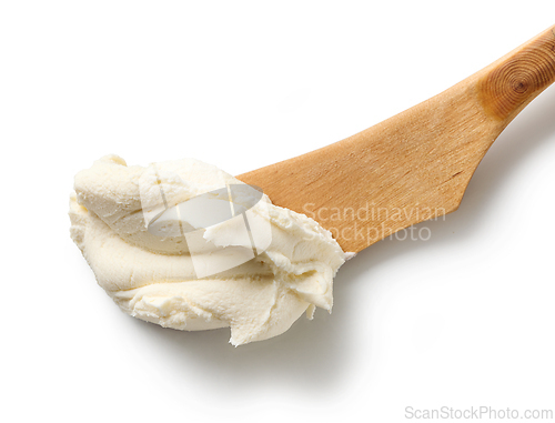 Image of fresh cream cheese on wooden knife