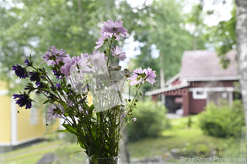 Image of wildflowers in a vase at the window