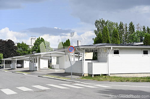 Image of a peaceful suburban neighborhood with modern white houses featur