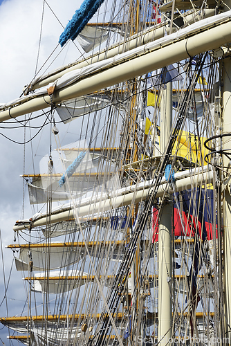 Image of close-up view of the intricate rigging, masts, and sails of a ta