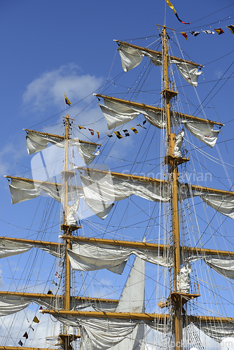 Image of close-up view of the intricate rigging, masts, and sails of a ta