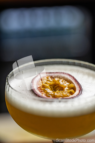 Image of Cocktail with foam, and passion fruit garnish