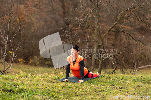 Image of Woman performing yoga stretching