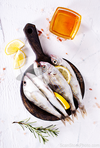 Image of small fish with salt and spice on board