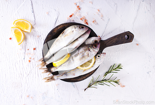 Image of small fish with salt and spice on board