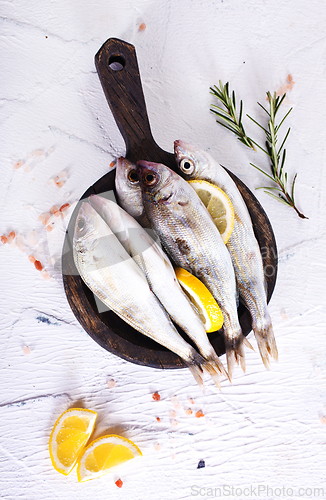 Image of small fish with salt and spice on board