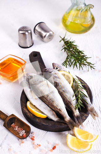 Image of small fish with salt and spice on board