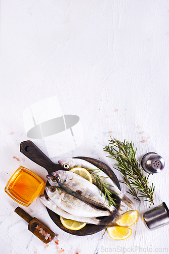 Image of small fish with salt and spice on board