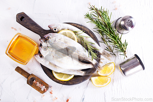 Image of small fish with salt and spice on board