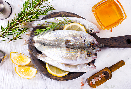 Image of small fish with salt and spice on board