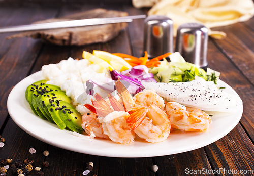 Image of Shrimp poke bowl with avocado, cucumbers and rice, diet food