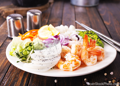 Image of Shrimp poke bowl with avocado, cucumbers and rice, diet food