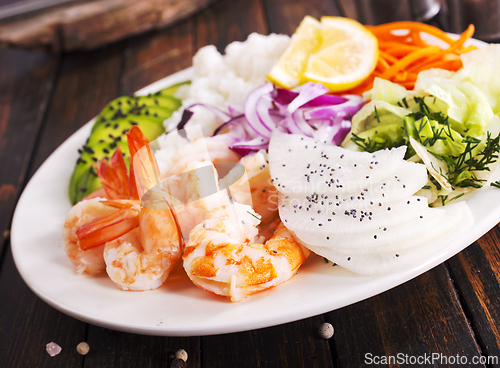 Image of Shrimp poke bowl with avocado, cucumbers and rice, diet food