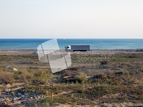 Image of The truck is standing on the shore.