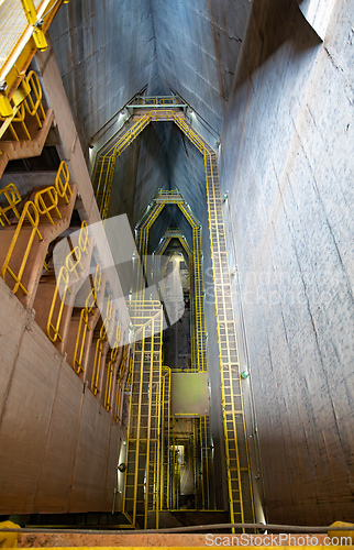 Image of Central access shaft, highlighting the immense vertical scale of the dam inner structure. Itaipu Binacional, Brazil