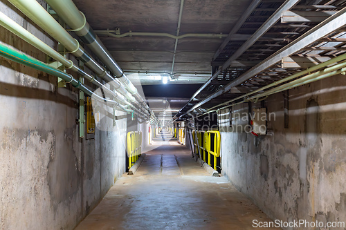 Image of Subterranean infrastructure of the dam, showing pipes and safety railings deep within the concrete wall. Itaipu Binacional, Brazil