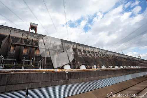 Image of Long concrete wall and multiple turbine outlets on the Parana River border shared by two nations. Itaipu Binacional, Brazil