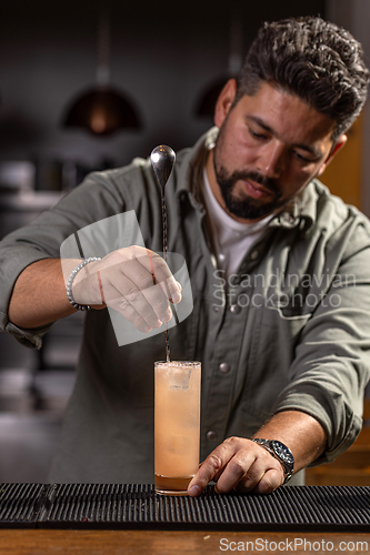 Image of Bartender mixing ingredients