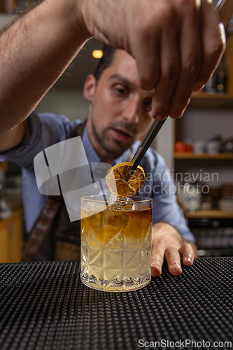 Image of Bartender garnishing a cocktail