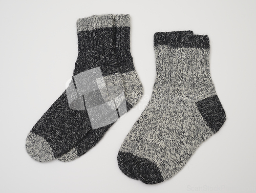 Image of two pair of knitted wool socks in two shades of grey