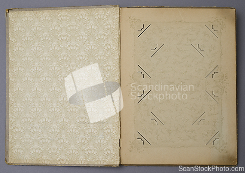 Image of an open vintage photo album with ornate decorative patterns