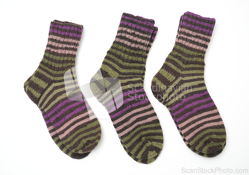Image of a pair of hand-knitted wool socks featuring a vibrant striped pa