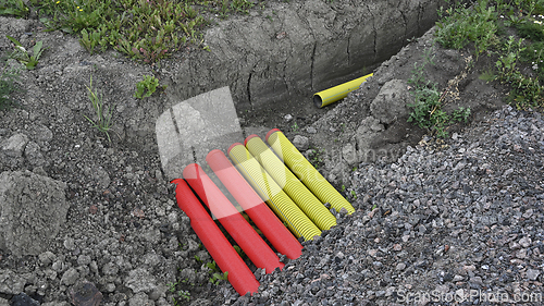 Image of a construction site with an excavation trench containing brightl