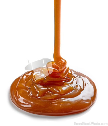 Image of caramel sauce pouring on white background