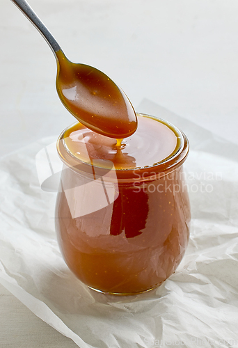 Image of freshly cooked homemade caramel sauce in jar
