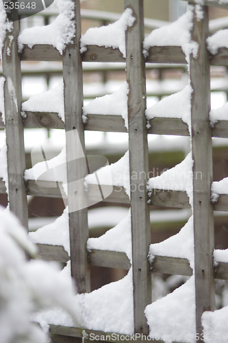 Image of snow settled on trelllis 