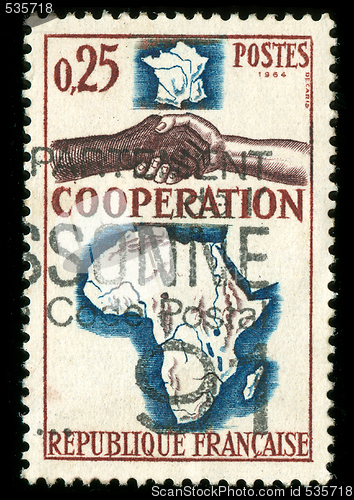 Image of vintage French stamp depicting a black and white man shaking hands