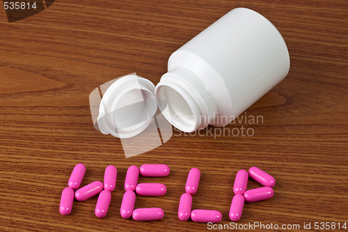 Image of Medicine capsules forming the word HELP