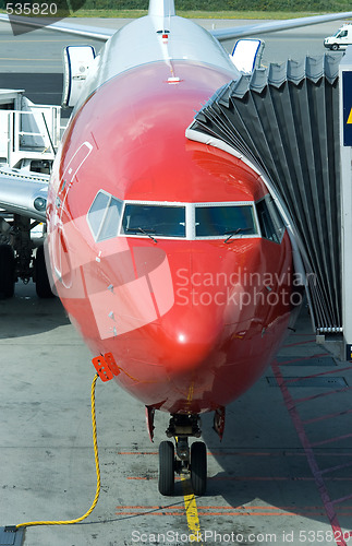 Image of Red airplane at the gate