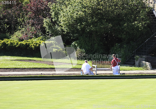 Image of two workers painting a seat