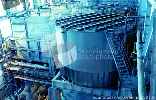 Image of Pipes, tubes, machinery and steam turbine at a power plant