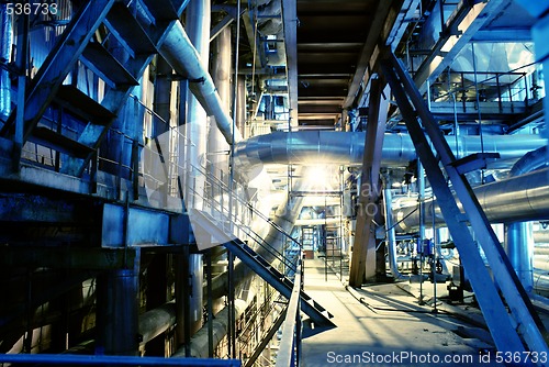 Image of Pipes, tubes, machinery and steam turbine at a power plant