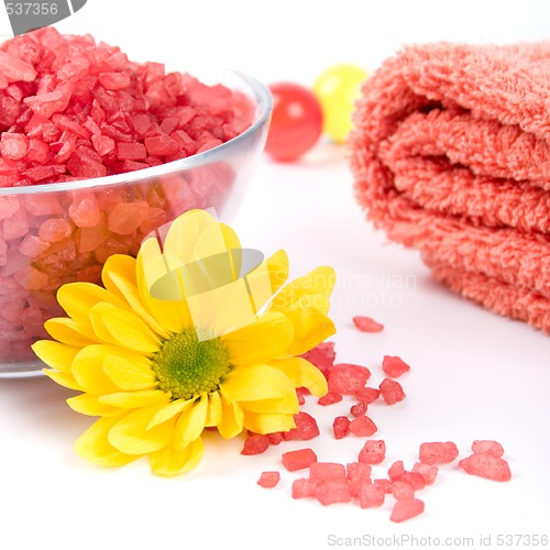 Image of bath salt, towel and flower