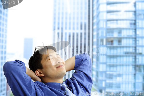 Image of Asian businessman resting