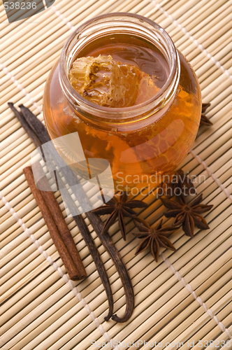 Image of fresh honey with honeycomb and spices