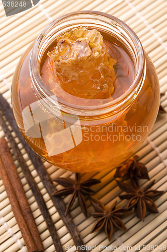 Image of fresh honey with honeycomb and spices