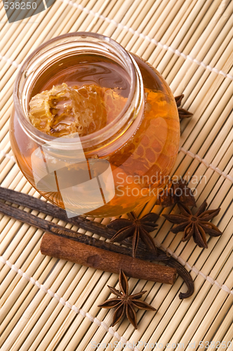 Image of fresh honey with honeycomb and spices