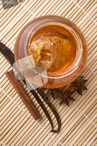 Image of fresh honey with honeycomb and spices